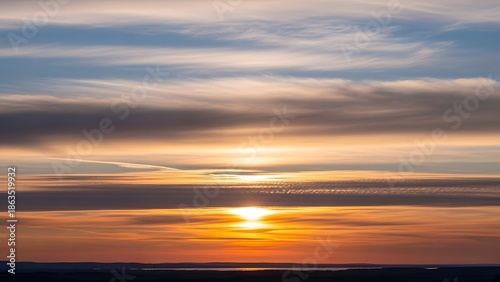 A breathtaking display of nature's artistry as the setting sun paints the sky with vibrant hues, creating a serene and captivating atmospheric panorama
