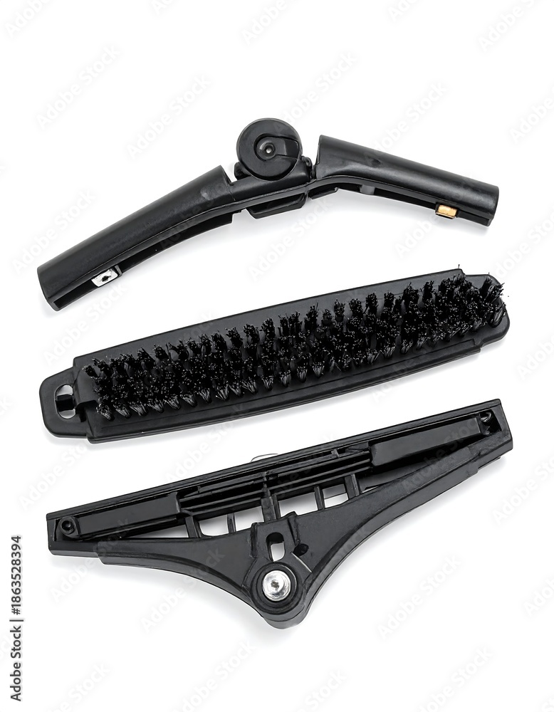 Fototapeta premium Three disassembled black tool parts laid out on a white surface
