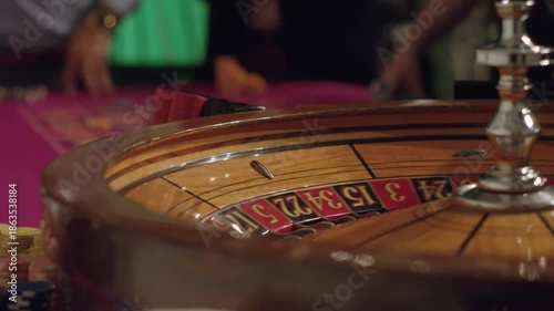 Casino Roulette Wheel Close-Up with Ball Rolling Around Table