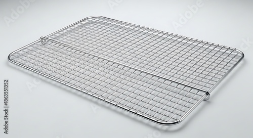 Rectangular wire cooling rack rests on a plain bright surface at an angle