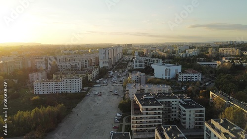 Fotografie Apartment buildings in city with sunset lighting