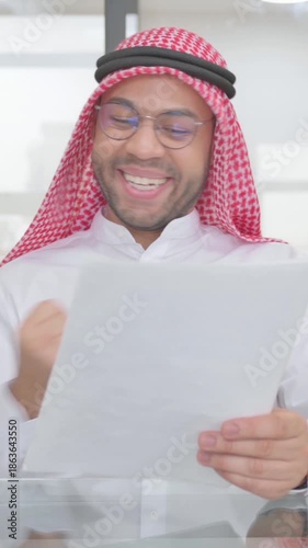 Young Muslim Man Celebrating while Reading Documents, vertical video