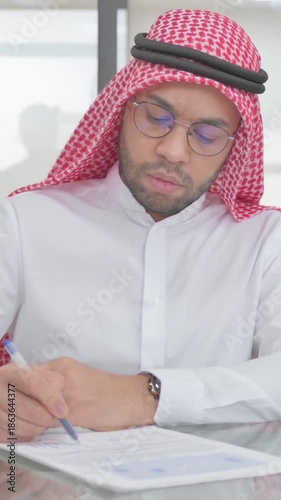 Young Muslim Man Working on Business Documents, vertical video