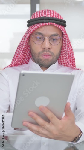 Young Muslim Man Using Digital Tablet for Work, vertical video