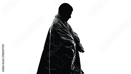 A silhouetted figure draped in a quilted jacket stands in profile against a stark white background creating a dramatic effect