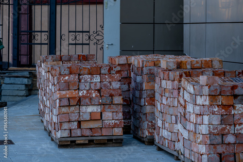 Old bricks are stacked on pallets.