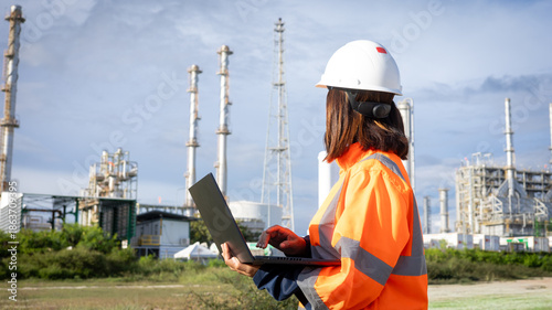 Obraz na płótnie A worker stands outside at an industrial site