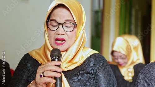 Elderly javanese woman singing traditional gamelan music