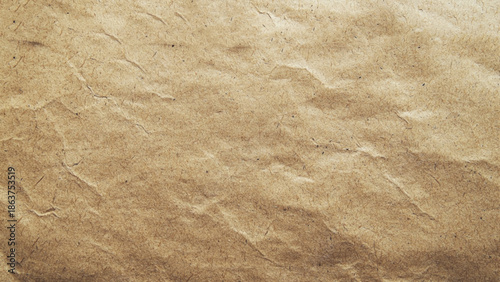 Old crumpled paper sheet or parchment texture background. Element for design. Top view.