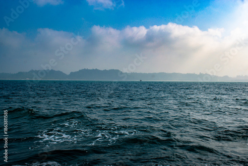 Sea and a boat alone blue sky