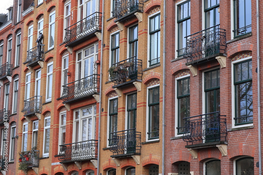 Fototapeta premium Bellamyplein Brick House Facades with Iron Balconies in Amsterdam, Netherlands