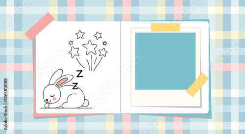 Cute baby scrapbook or photo album page with a drawing of a sleeping bunny, stars, and a blank photo frame on a plaid background.