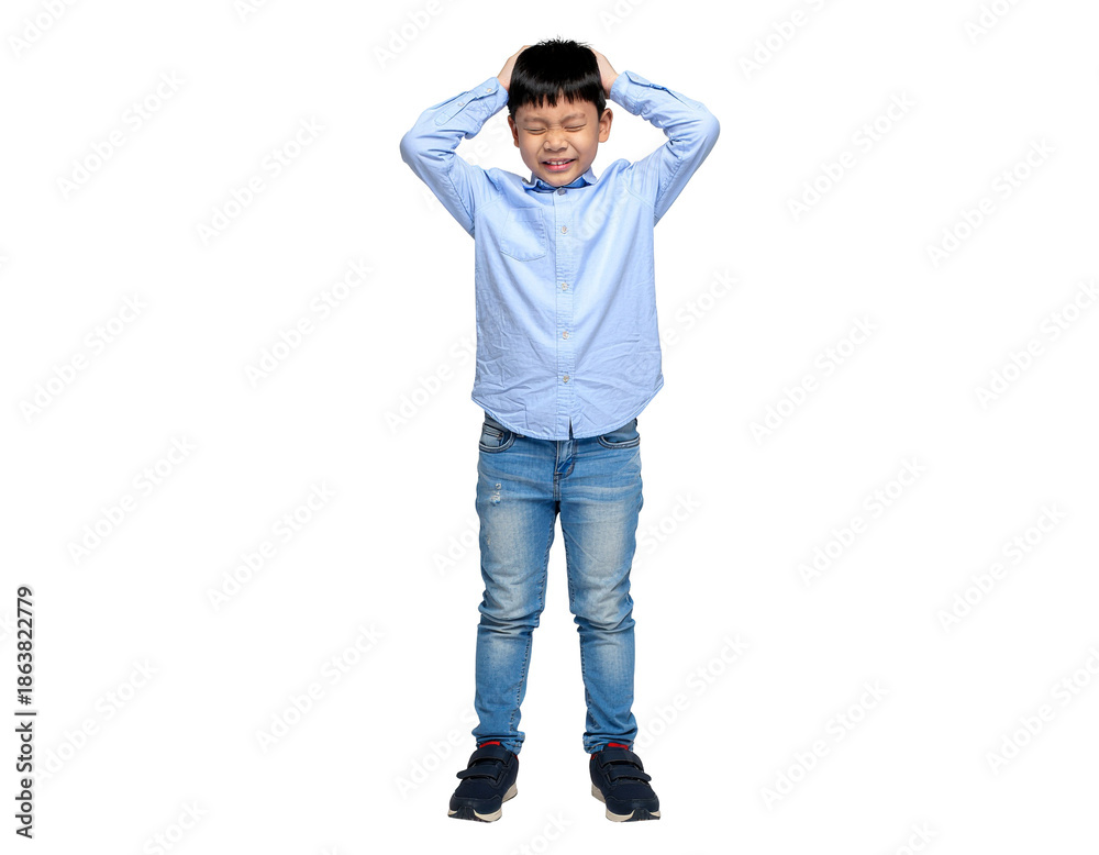 Naklejka premium Playful boy in light blue shirt and jeans covering his ears with a surprised expression