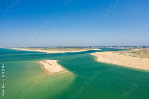 фотографія Expansive aerial panorama of the Barre d'Etel sandbank with turquoise water and golden sandy shores under a clear blue sky