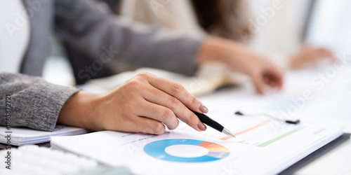 Foto close up hands of Business partners working with analysis report and advisor showing plan, Two businesswoman working with Financial analysts reports and planning investment at office