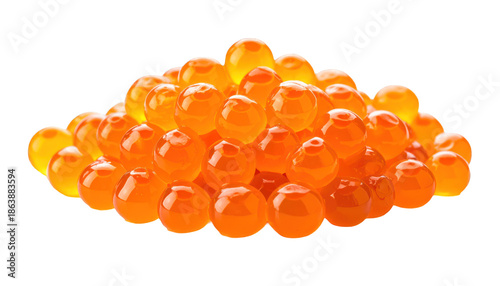 A close-up of a vibrant pile of translucent, spherical, orange-red eggs on black