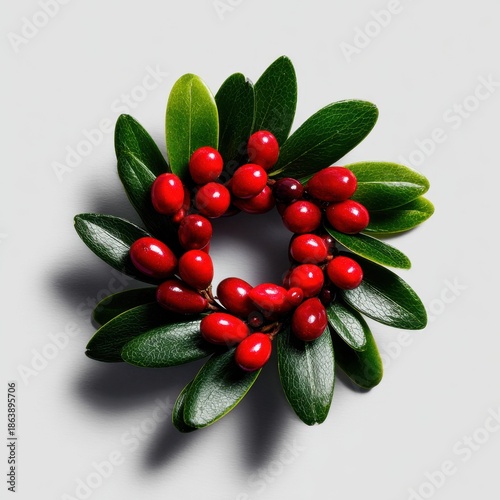 Close-up of minimalist holiday wreath with pine and red berries festive decor style