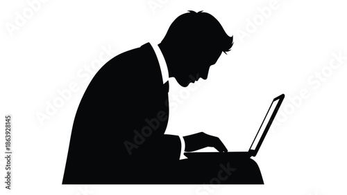 Silhouette of businessman deeply focused while typing intently on a modern portable computer