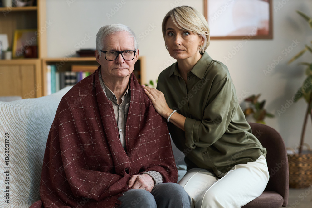 custom made wallpaper toronto digitalPortrait of senior Caucasian man sitting with blanket over shoulders, middle aged Caucasian woman standing beside him placing hand on his shoulder, both looking at camera