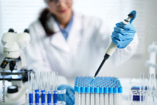 Bild auf Leinwand Asian adult scientist researcher experiment liquid pipetting precise accurate wo