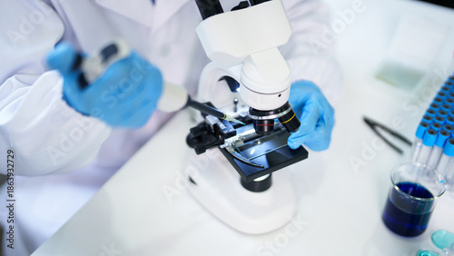 Tableau sur toile Adult scientist researcher performs precision liquid transfer with micropipette