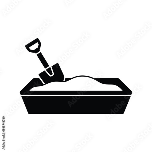 A simple black and white illustration of a sandbox with a shovel