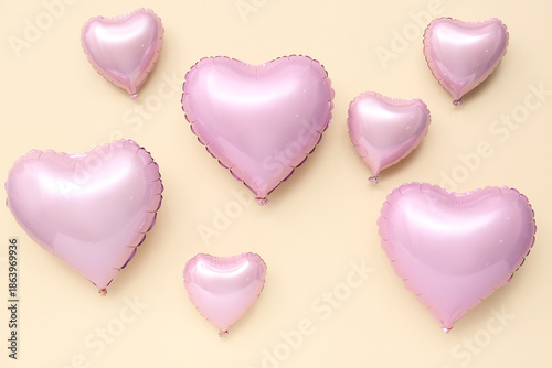 Pink heart shaped air balloons on beige background. Valentine's day celebration
