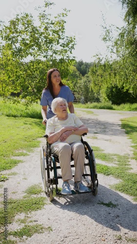 Home nurse taking care of elderly woman in wheelchair.