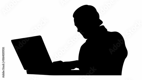 Silhouette of a person working on a laptop in a dark room