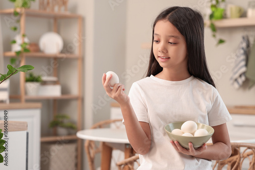 Cute Asian girl with bowl o...