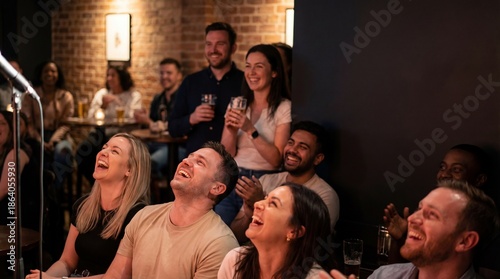 Diverse audience laughing heartily at a comedy show in a dimly lit club