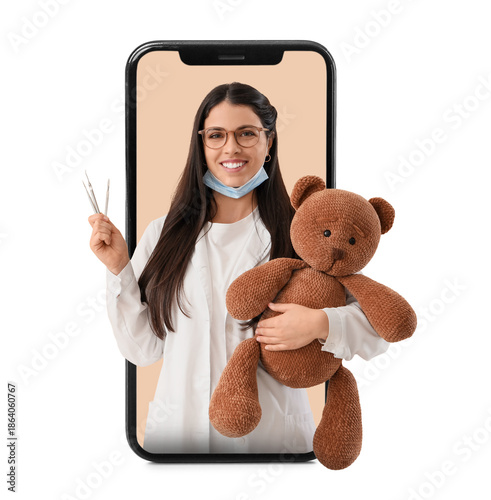 Female dentist with toy bea...