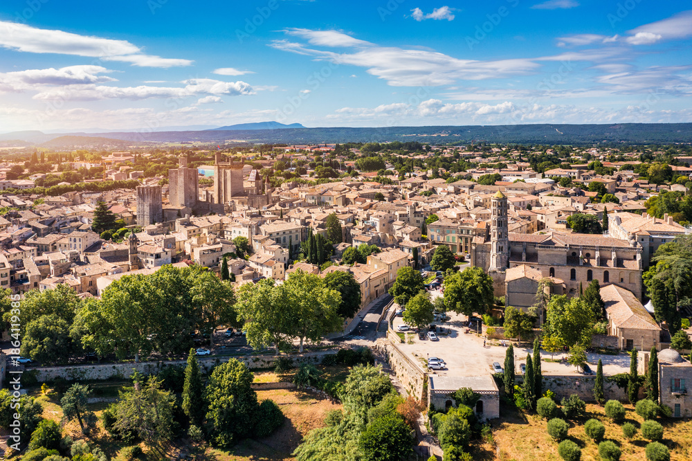 Fototapeta premium View of beautiful town of Uzes, Gard department, France. Aerial view of the historic town of Uzes, France. Historic town of Uzes with stunning aerial views of its medieval architecture, Gard, France.