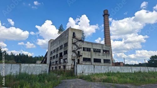 Εκτύπωση καμβά abandoned factory atmosphere, a deserted industrial building in a grassy area, w