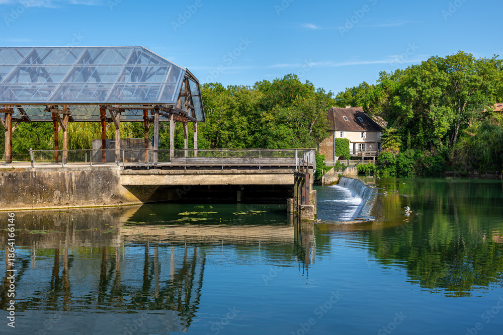 Fototapeta premium Clain river in Poitiers, modern glass structure and lush greenery