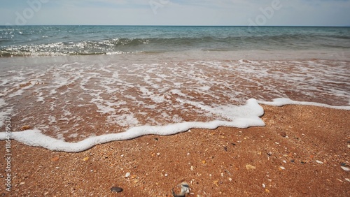 Bild auf Leinwand Soft waves gently lapping the sandy shore of a crimean beach on a summer day, cr