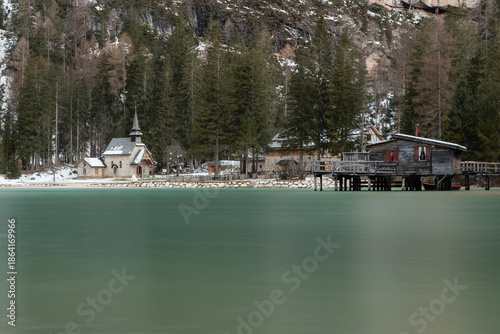 Lago di braies reflecting winter alpine landscape