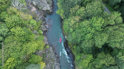 rafting down a mountain river from a bird's-eye view, forest, autumn