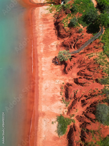 Arial view of Simpson Beach in Broome, Western Australia, showcasing turquoise waters, white sand coastline and tropical landscape in the Kimberley region captured by drone