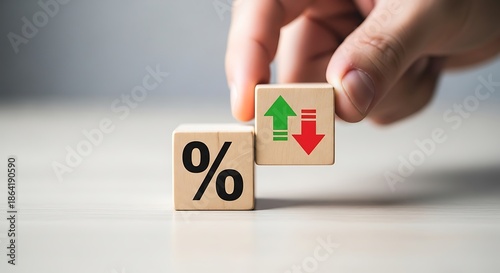 Hand positioning wooden block illustrating fluctuating percentage rates and financial market volatility