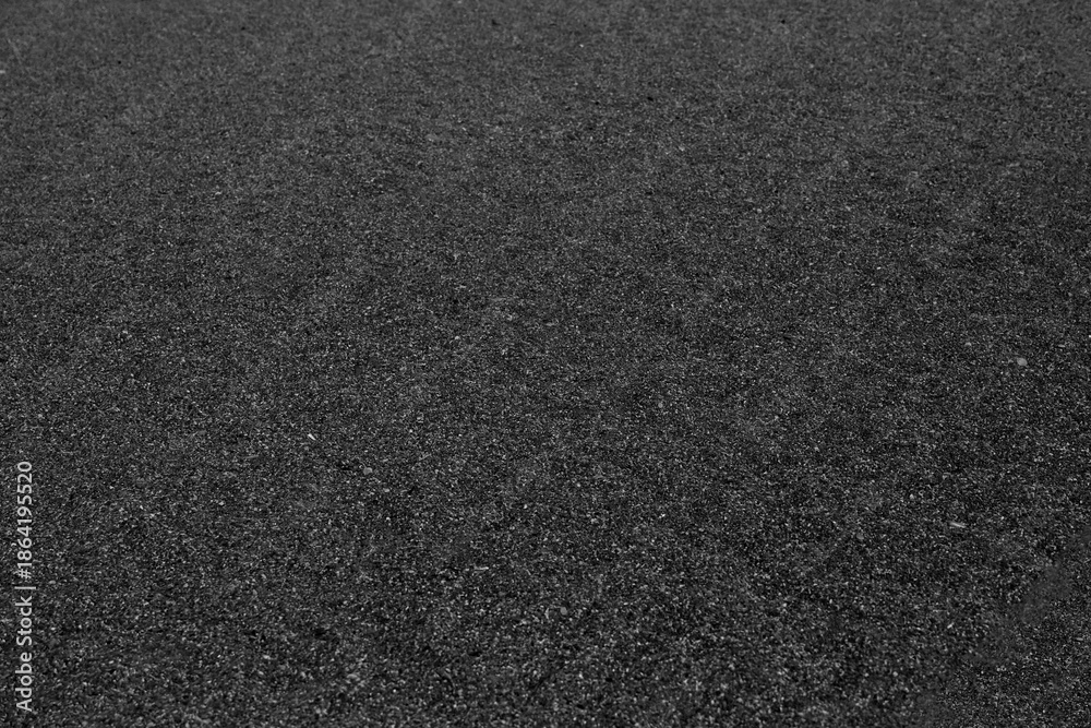 Fototapeta premium Top view Black white sand texture background. Black Friday background concept. Volcanic black sand close up copy space top view background.