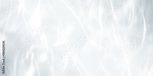 A bright and clean abstract background with soft, flowing white light and caustic reflections. A minimalist and elegant design resembling water or crystal.