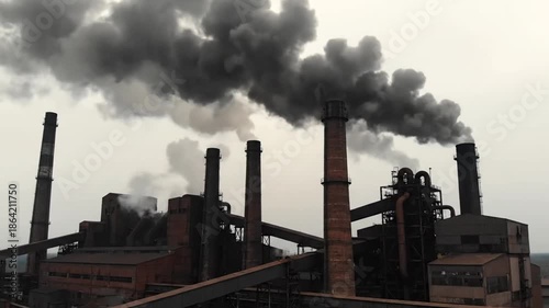 Industrial complex chimneys emitting smoke