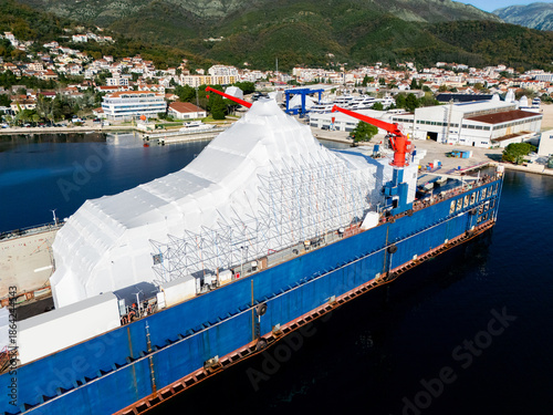 Canvas Print Aerial view of a luxury yacht refit, repair, service and maintenance in a floating dock at a marina