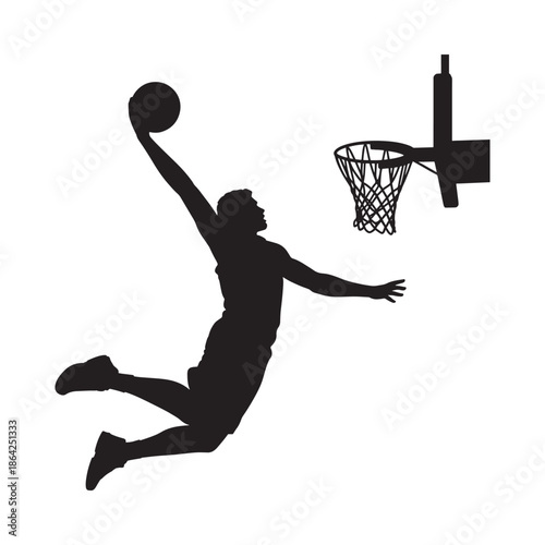 Silhouette of basketball player dunking ball into hoop