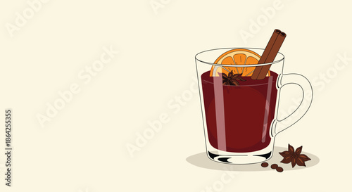 A warm glass mug of mulled wine with an orange slice cinnamon stick and star anise perfect for a cozy autumn or winter day.