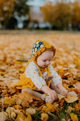 Baby Girl Rejoices, Smiles Sincerely Because Of Falling Autumn Leaves In Warm