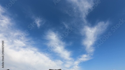 Stunning timelapse footage of fluffy white clouds drifting across a bright blue sky. Captured in high-resolution, perfect for background visuals, time-lapse projects, or nature-themed productions.
