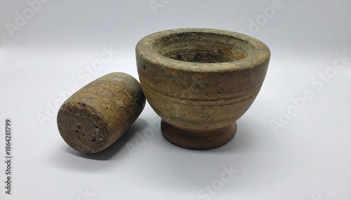 a traditional mortar and pestle set: a handmade clay mortar