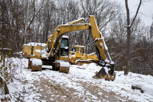 excavators covered in snow